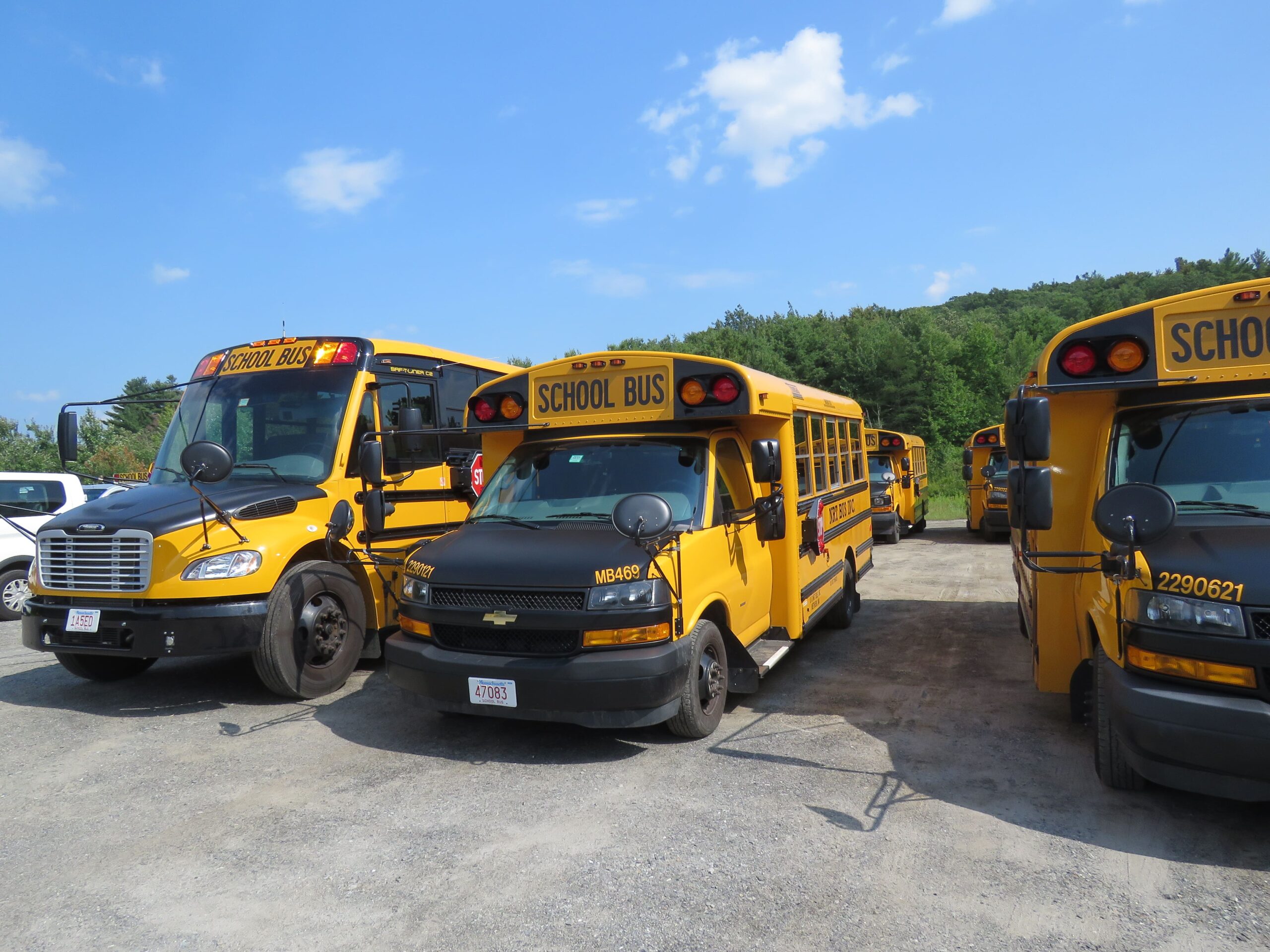 Winter school bus operated by Van Pool Transportation driving safely on snowy roads in Wilbraham, MA