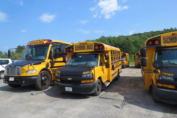 Winter school bus operated by Van Pool Transportation driving safely on snowy roads in Wilbraham, MA